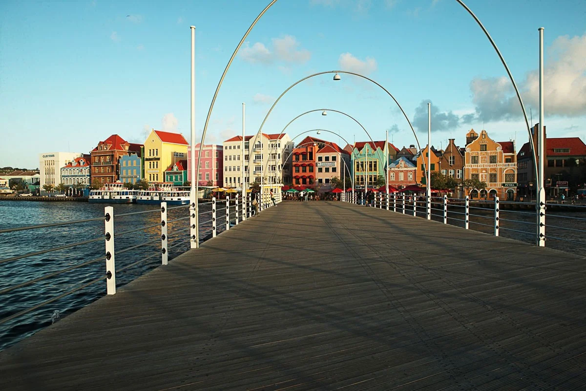 Queen Emma Bridge leading toward the colorful waterfront of Willemstad, Curaçao