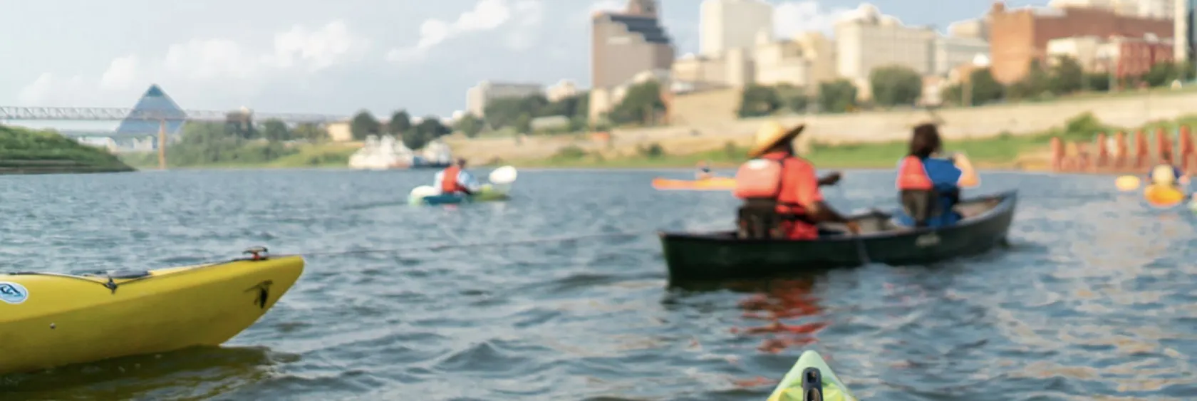 Kayakers on the Mississippi River with the Memphis skyline beyond